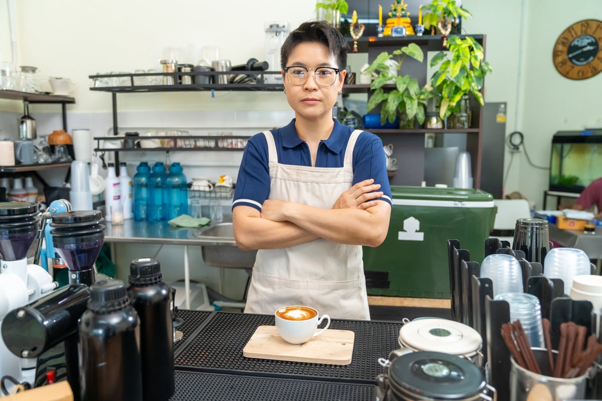 Barista serving a cafe latte to a customer at the Lab's counter
